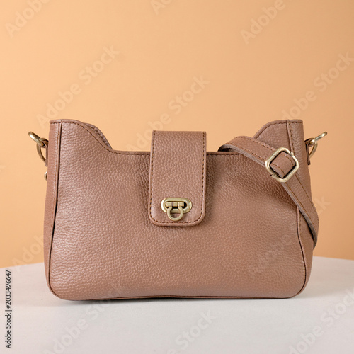 Beautiful brown leather bag for women set on a brown background, perfect for a leather product catalog design
