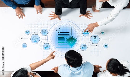 Tableau sur toile A group of professionals collaborates over a pivotal document, highlighting aspects of security and compliance within a modern business environment