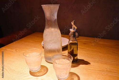 Quadro su tela Elegant Table Setting with Water Carafe, Glasses, and Olive Oil Bottle