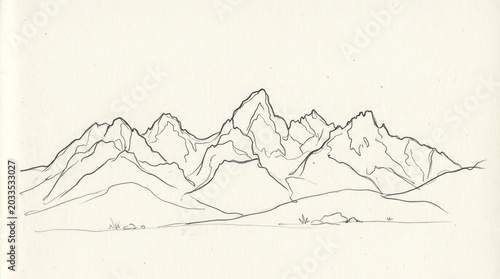 A mountain range with snow-capped peaks, rocky terrain, and a clear sky in the background.