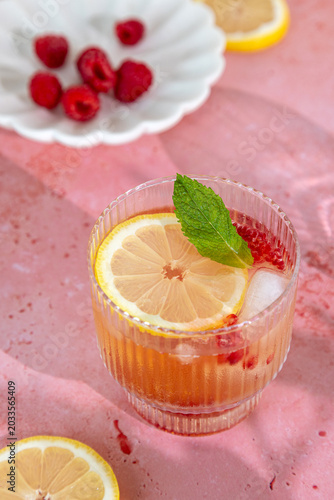 Raspberry lemon spritz summer refreshing cocktail on pink background