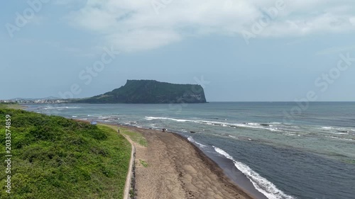 Aerial drone view of Seongsan Ilchulbong in Jeju Island with ocean volcanic landscape and coastal scenery