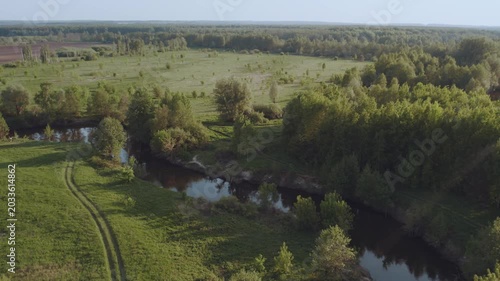 Aerial survey of forest by the river, flooded forest, forest at sunset