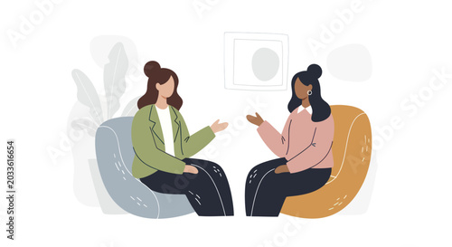 Фотография Two women engaged in conversation sitting in chairs.