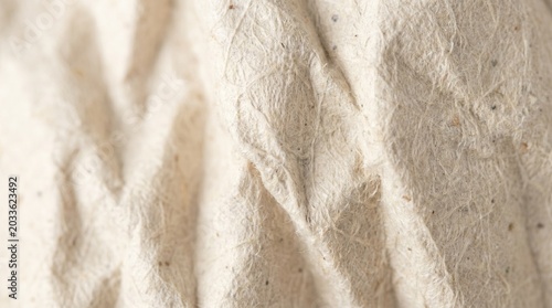 Close-up of rough, crumpled paper showing intricate texture and natural fiber details for design backgrounds.