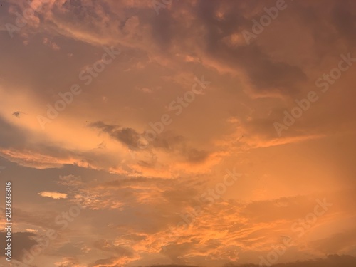Cinematic orange sunset clouds with dramatic pastel sky and soft texture, captured in wide-angle focus. Perfect for luxury branding, wellness ads, travel banners and aesthetic wallpapers.
