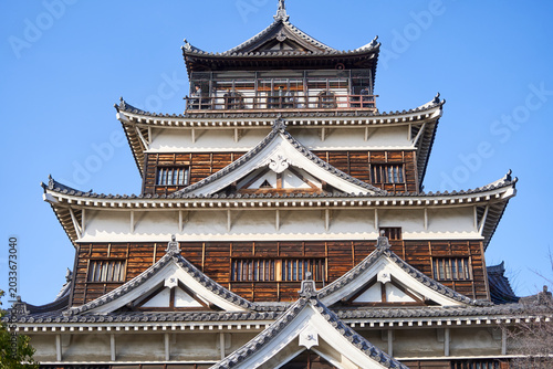Εκτύπωση καμβά A close-up view of Hiroshima Castle's main keep (tenshu) against a clear blue sky, showcasing traditional Japanese feudal architecture
