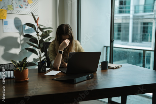 Businesswoman Reading Resignation Letter in Office