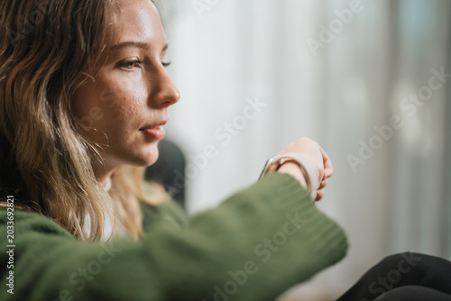Businesswoman Using Smartwatch While Working From Home