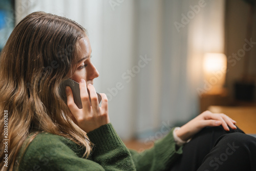 Businesswoman Taking Phone Call While Working From Home