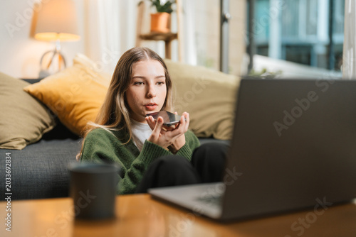 Businesswoman Using Speech to Text on Smartphone While Working From Home