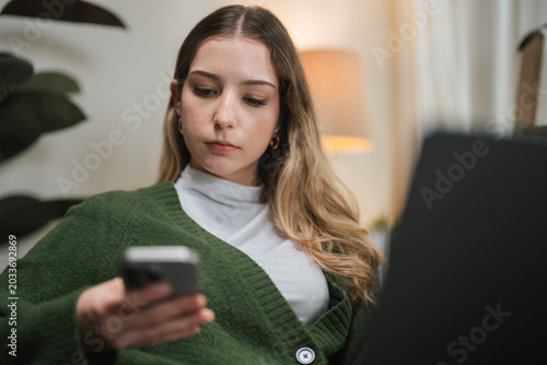 Businesswoman Taking Phone Call While Working From Home