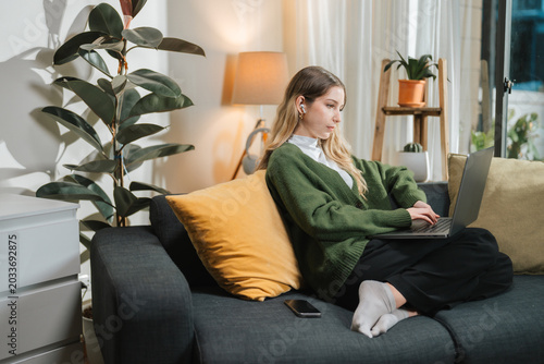 Businesswoman Taking Phone Call While Working From Home