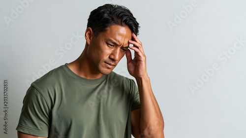 Man suffering from severe migraine touching his head. Asian guy in pain feeling headache. Health problem, stress, tension, physical discomfort and medical concern concept on white background.