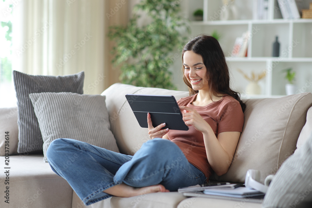 Fototapeta premium Happy young student watching online content on digital tablet