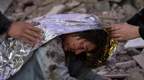 Emergency rescue child under foil blanket at shelter after disaster, injury aid and debris recovery