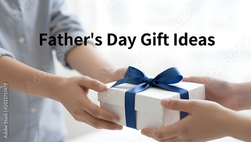 Child hands presenting a holiday gift box to father, Father's Day gift ideas concept