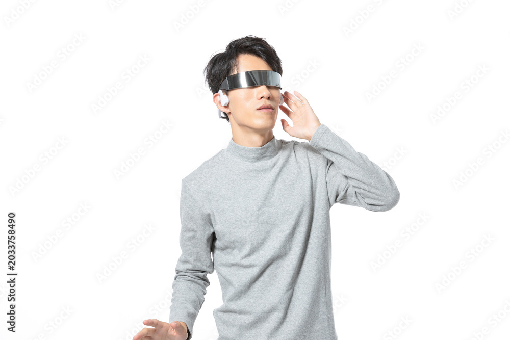 Fototapeta premium Young Man Wearing Futuristic Smart Glasses and Earbud