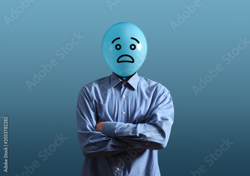 Man with balloon head having worried expression