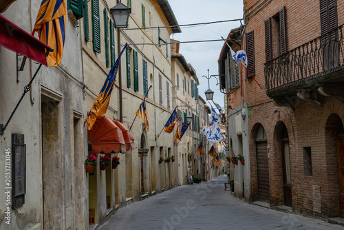 Canvastavla Street of Montalcino with flags, Tuscany, Italy
