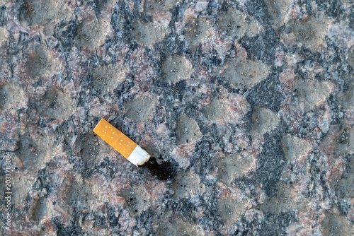 cigarette butt on walkway stone outdoors