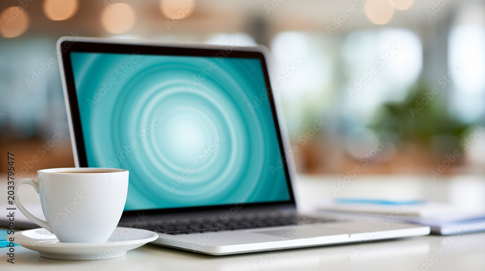 Fototapeta premium Laptop and coffee cup on table with blurred background indoors 
