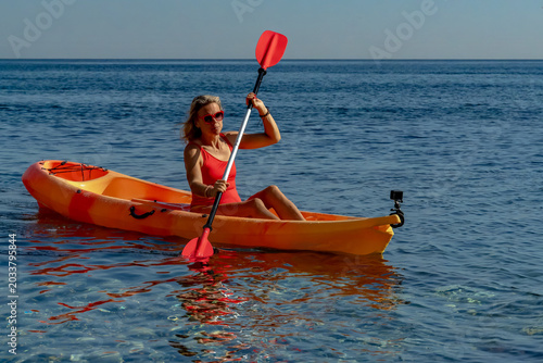 Kayak, Woman, Ocean: Female paddler enjoys summer vacation on calm blue water.