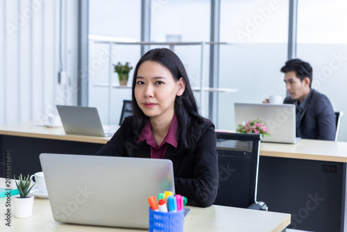 Successful company,executive Happy of smiling Young Asian business woman in the workplace working with laptop computer of Office staff of business people and support Teamwork in meeting room at office