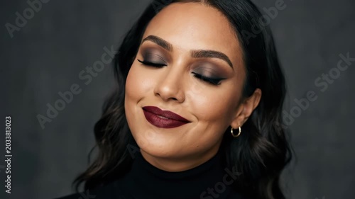 Attractive woman with strong makeup, bold beauty portrait with polished cosmetics focus, confident expression and premium editorial appeal for makeup and fashion campaigns, minimal backdrop, soft
