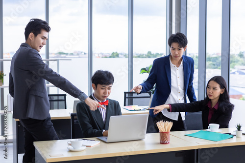 Successful happy workers Group of asian business people with diverse genders (LGBT) and congratulate to Homosexual businessman see a successful business plan on the laptop computer at office