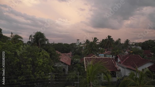 Sunset timelapse with tiled roofs and lush tropical greenery from Sri Lanka hotel