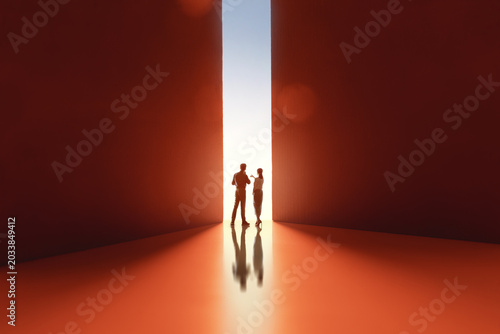 Silhouettes of Two People Discussing Ideas in Abstract Corridor with Dramatic Lighting