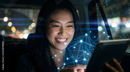 Happy Woman Using Digital Technology in Car at Night