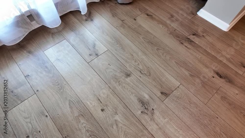 Natural wood laminate parquet floor. Room with laminate in new apartmen. Cozy home interior, modern design