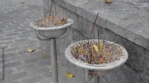 Burning aroma sticks in buddhist temple at asia on blurred background