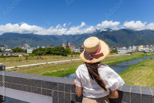 Bild auf Leinwand Female traveler enjoying the scenic mountain view on a sunny day