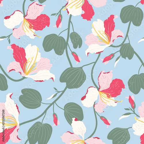 Tropical seamless pattern with pink Bauhinia flowers and green leaves on pastel blue background vector