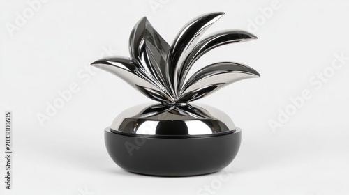 Polished metal decorative container with stylized plant design.