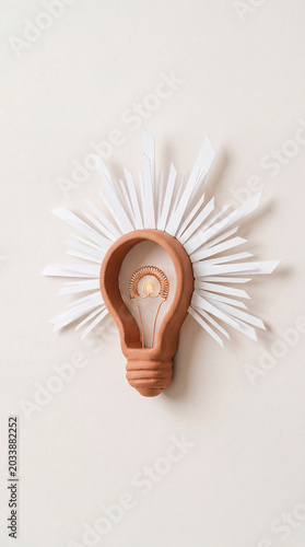 Plasticine light bulb with paper rays idea creativity concept