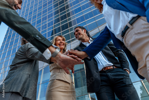 Business team stacking hands showing unity and support