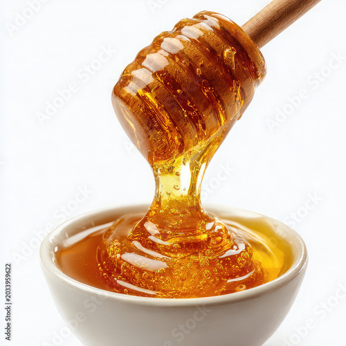 honey dripping from a wooden dipper