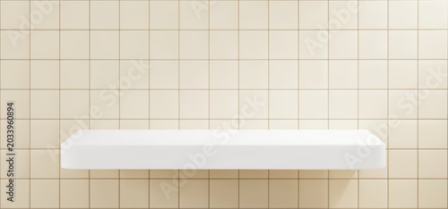 Beige tile bathroom wall background with white shelf . Minimal mockup with empty ledge display for cosmetic product presentation or branding design.