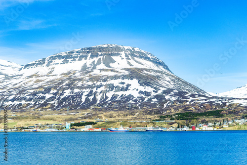 Harbor and ships in town of Reydarfjordur in east Iceland on sunny spring day