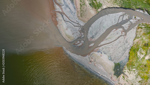 Canvas Print An aerial view of the mouth of a river or stream where it flows into a lake or the sea