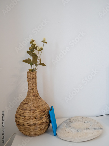 Minimalist Still Life with Wicker Vase, Natural Stone and Blue Smartphone