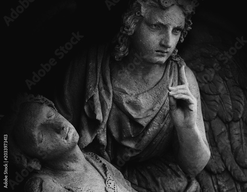 Angel of death leads human in the last path. Death concept.   Fragment of an ancient statue.