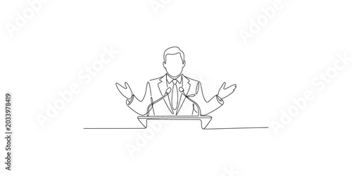 Fotografía A man in a suit standing at a podium with his hands outstretched in a gesture of