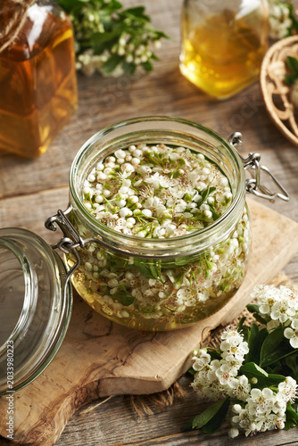 Making herbal tincture from fresh hawthorn flowers