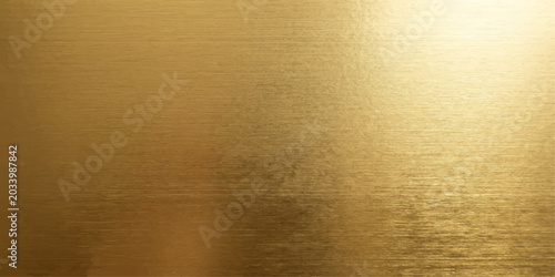 Fényképezés A brushed gold metallic surface reflecting warm light, creating an abstract and luxurious textured background