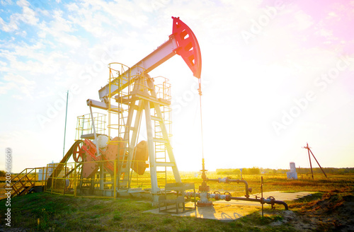 Konstfotografi Pumpjack in oil well of oil field on sunset